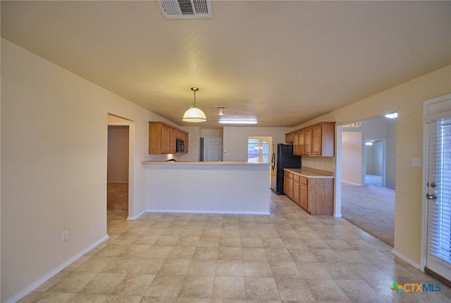 kitchen featuring kitchen peninsula, pendant lighting, light colored carpet, and black appliances