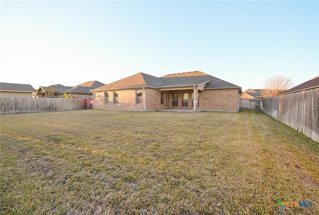 rear view of property featuring a yard