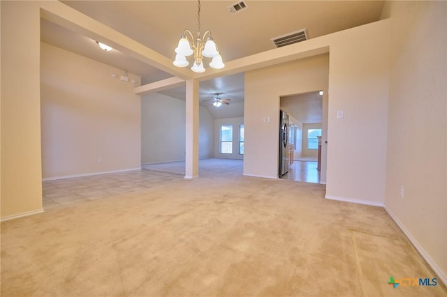 unfurnished room featuring french doors, light colored carpet, and ceiling fan with notable chandelier