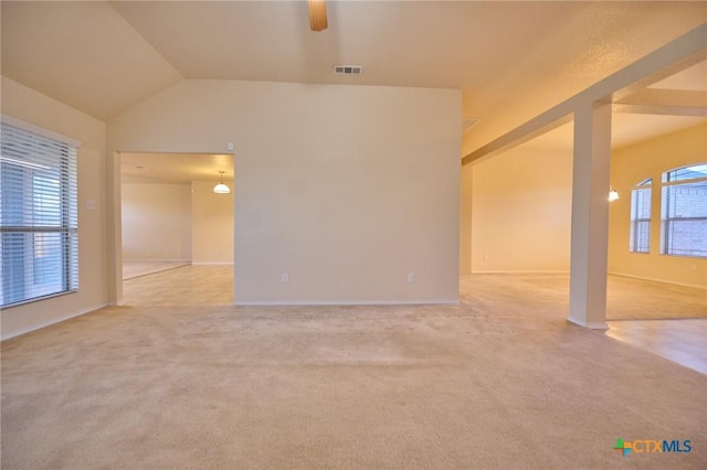 carpeted empty room featuring ceiling fan and vaulted ceiling