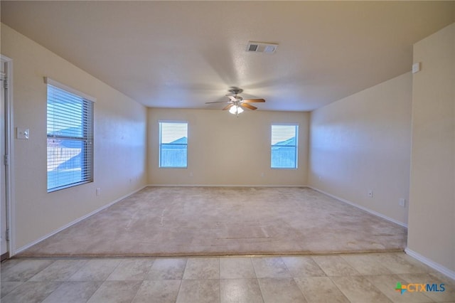 carpeted spare room with ceiling fan