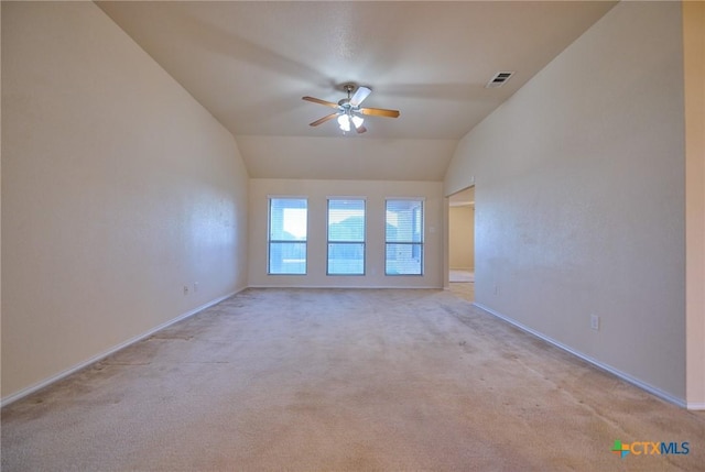 carpeted spare room featuring ceiling fan and lofted ceiling