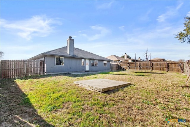 back of property featuring a patio area and a yard