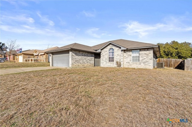 ranch-style house featuring a front yard, central air condition unit, and a garage