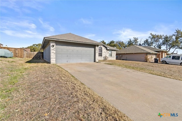 single story home featuring a garage and a front yard