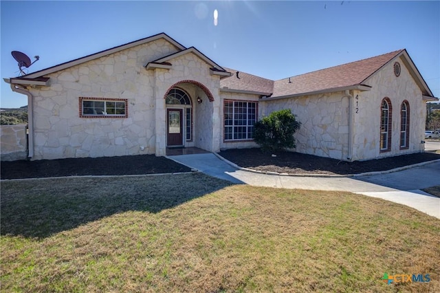 ranch-style house with a front lawn