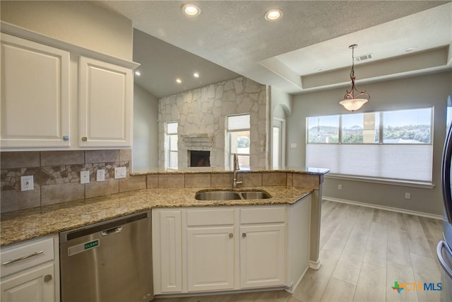 kitchen featuring white cabinetry, light stone countertops, sink, and stainless steel dishwasher