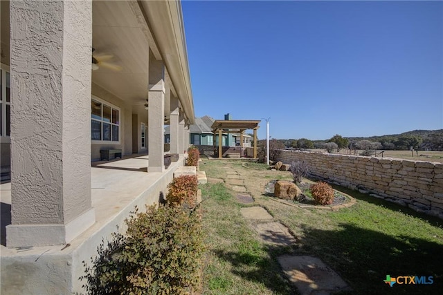 view of yard featuring a patio and ceiling fan