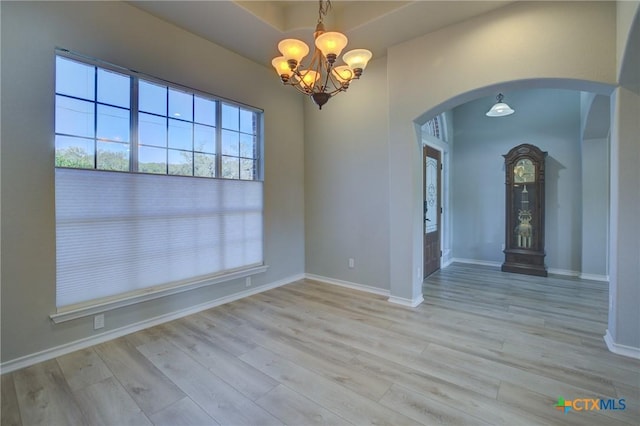 interior space with an inviting chandelier and light hardwood / wood-style floors