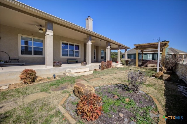 back of property with a pergola, a patio area, and ceiling fan