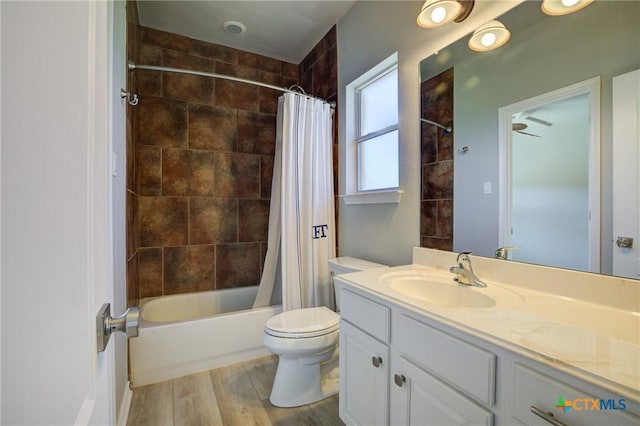 full bathroom featuring vanity, toilet, hardwood / wood-style floors, and shower / bath combo