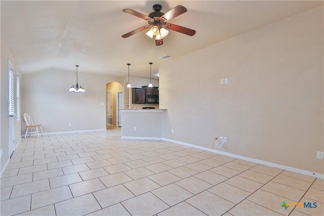 unfurnished living room with light tile patterned floors, ceiling fan with notable chandelier, and vaulted ceiling