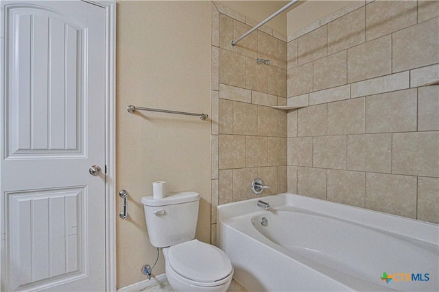 bathroom with tiled shower / bath combo and toilet