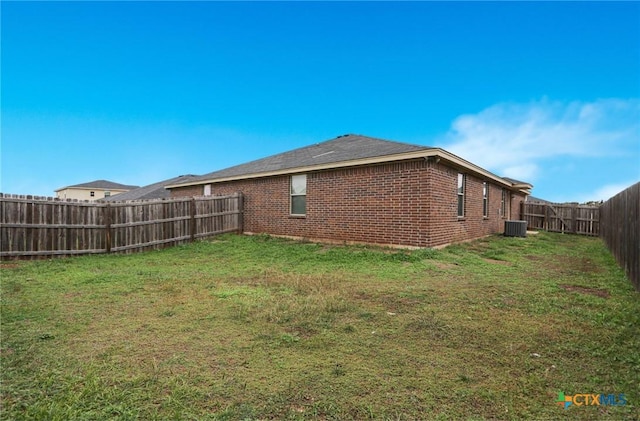 exterior space featuring central AC and a lawn