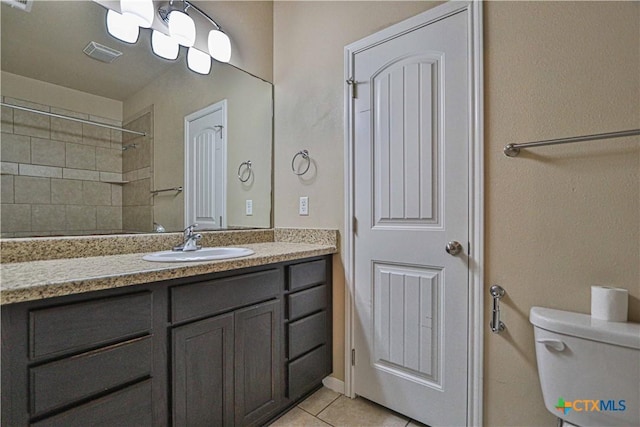 bathroom featuring tile patterned floors, vanity, and toilet