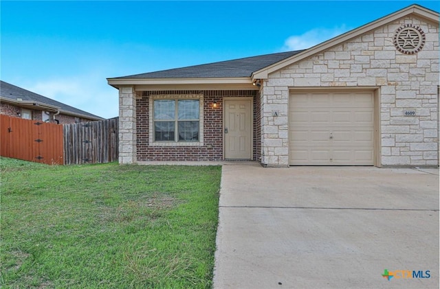 single story home featuring a front yard and a garage