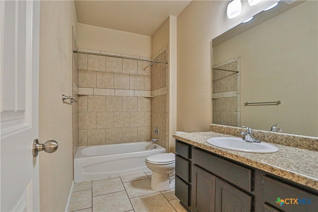 full bathroom featuring tile patterned floors, tiled shower / bath combo, toilet, and vanity