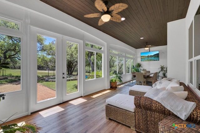 sunroom with wood-type flooring, wood ceiling, a wooden deck, and french doors