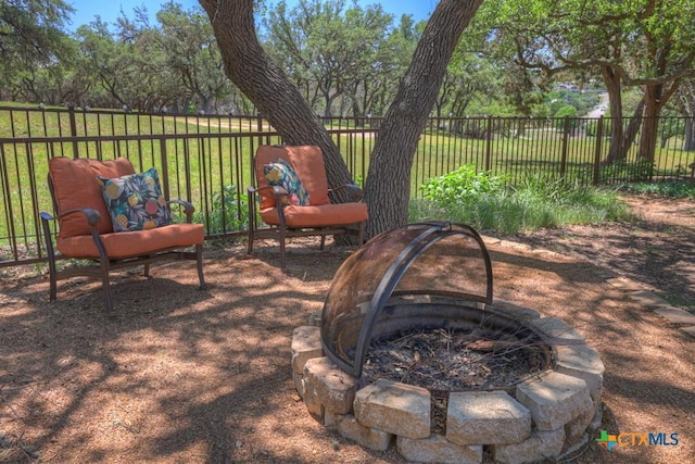 view of patio / terrace featuring a fire pit and fence