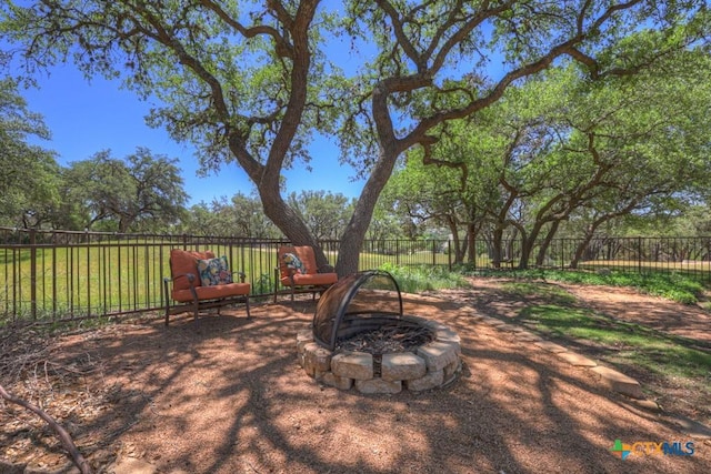 view of patio / terrace with a fenced backyard and an outdoor fire pit
