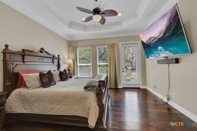bedroom with crown molding, wood-type flooring, a tray ceiling, and access to exterior