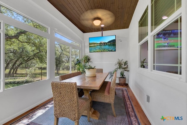 sunroom / solarium with wood ceiling, baseboards, and wood finished floors