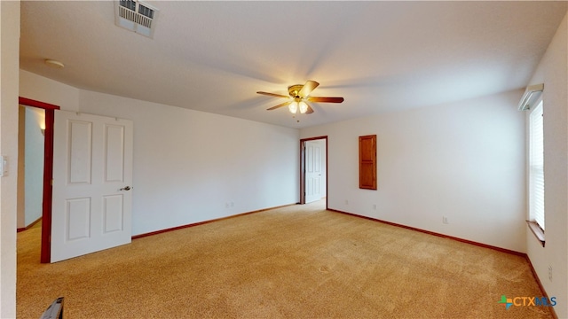 empty room with ceiling fan and light carpet