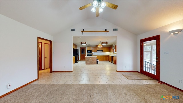 unfurnished living room with ceiling fan, high vaulted ceiling, and light carpet