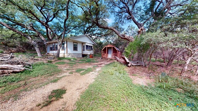 view of front of property with a storage shed