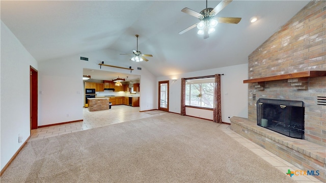 unfurnished living room with high vaulted ceiling, a fireplace, light colored carpet, and ceiling fan