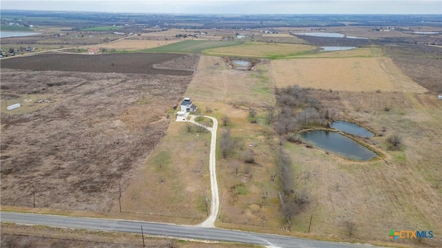 drone / aerial view with a rural view and a water view