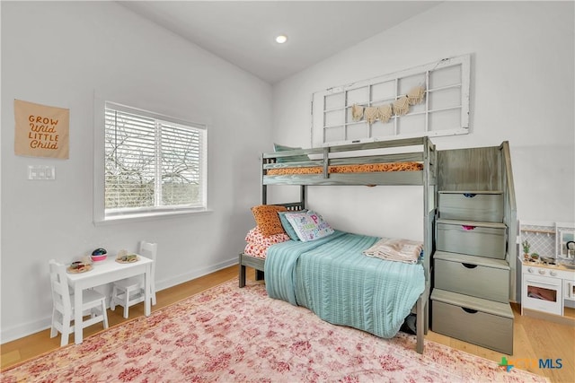 bedroom featuring vaulted ceiling and hardwood / wood-style floors