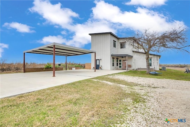 exterior space featuring a front yard and central AC unit