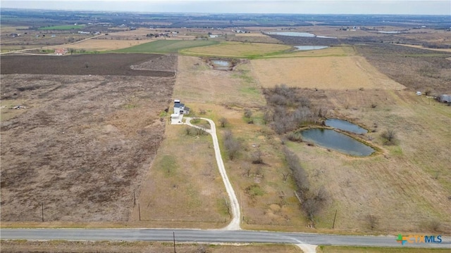 drone / aerial view with a rural view and a water view