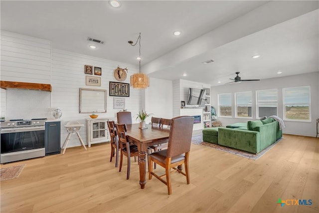 dining room with ceiling fan and light hardwood / wood-style flooring