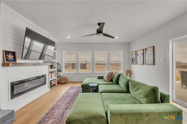 living room featuring ceiling fan and light wood-type flooring