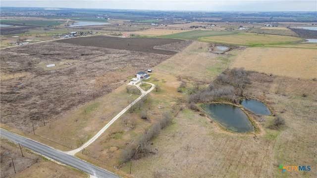 drone / aerial view featuring a water view and a rural view