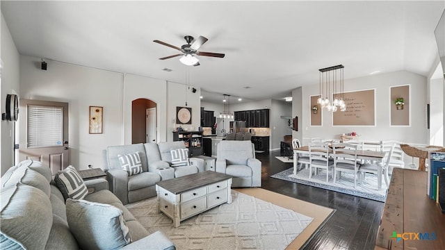 3616 Blue Cloud Dr, New Braunfels, TX 78130 - living area featuring a chandelier, a ceiling fan, light wood finished floors, and arched walkways