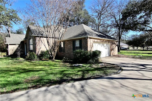 view of home's exterior with a lawn and a garage