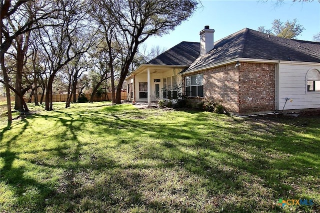 rear view of house with a yard