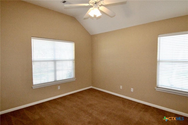 spare room with a wealth of natural light, carpet floors, and lofted ceiling