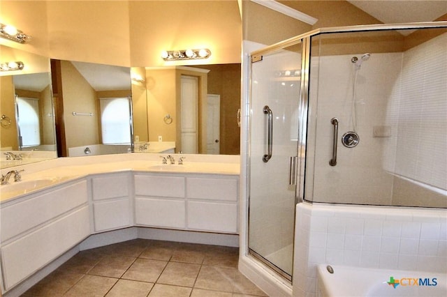 bathroom featuring plus walk in shower, vanity, and tile patterned floors