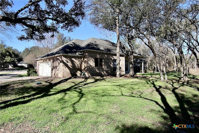 view of property exterior with a garage and a yard