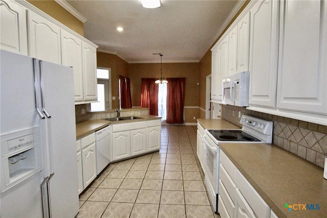 kitchen with decorative backsplash, white cabinetry, white appliances, and hanging light fixtures