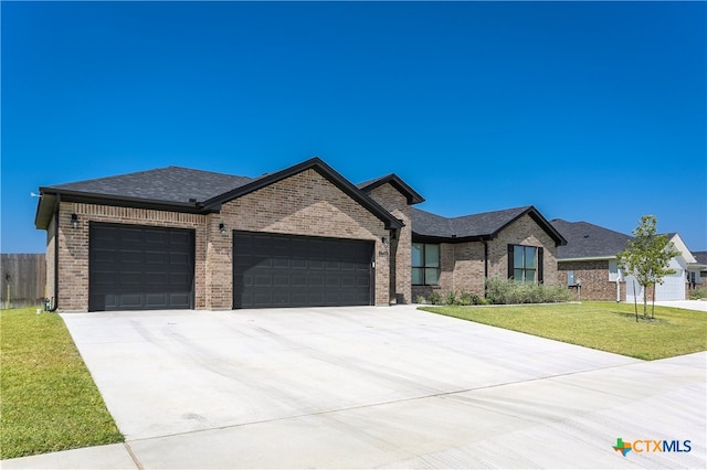 view of front of property with a garage and a front lawn