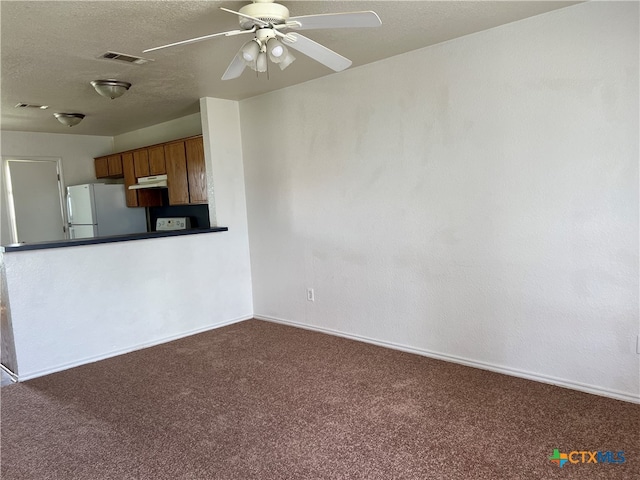 kitchen featuring white refrigerator, dark colored carpet, and ceiling fan