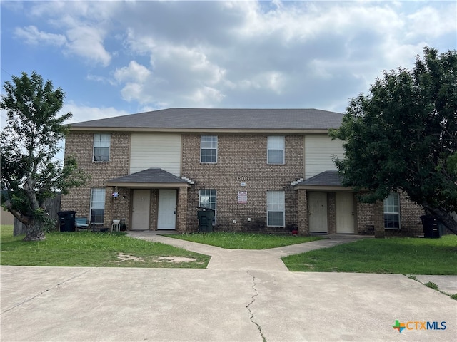 view of front of home with a front lawn and a garage