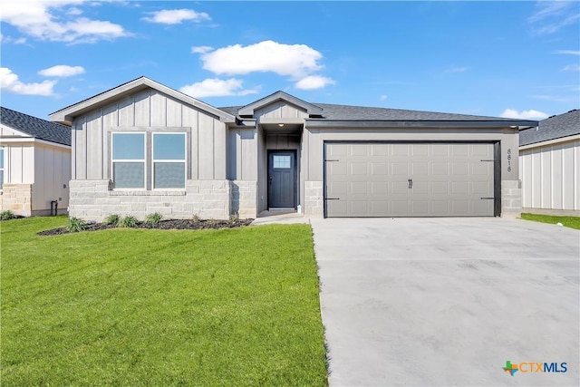 view of front of property featuring a garage and a front lawn