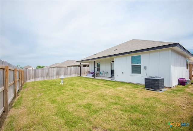 back of property featuring central AC unit, a yard, and a patio area