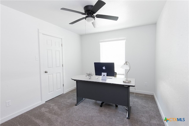 office space featuring ceiling fan and dark carpet